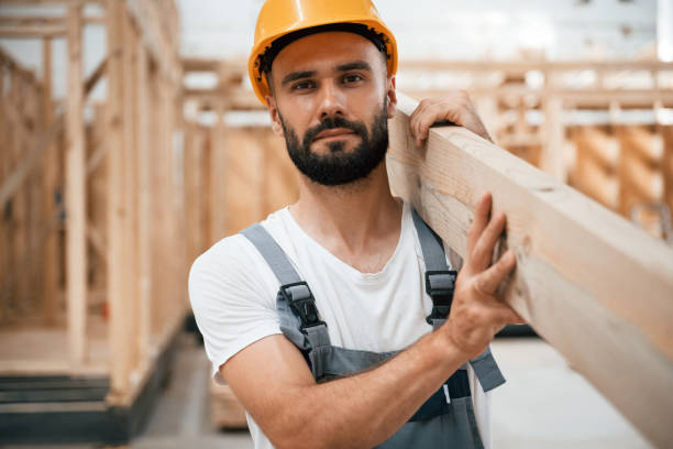 istock Front view, holding plank. Industrial worker in wooden warehouse 2163588483