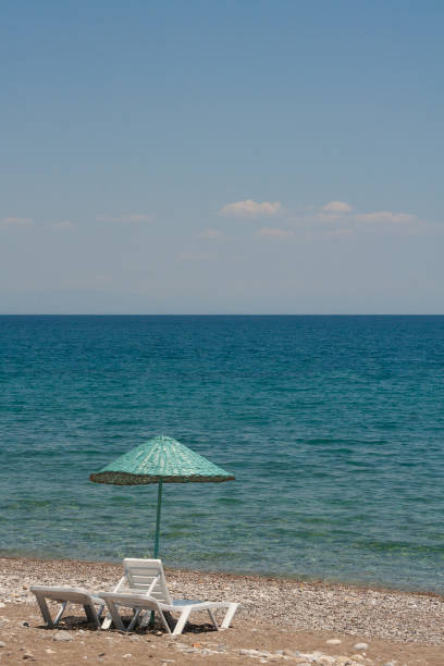 deck chairs and umbrellas on the sea beach in summer