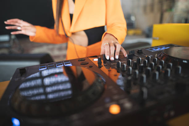 a DJ plays music on a controller at a party