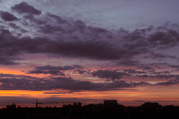 Evening over the metropolis. Outlines of houses. Bright colors of the evening sky. Multicolored clouds over Kyiv. Nature of Ukraine. Urban landscape.