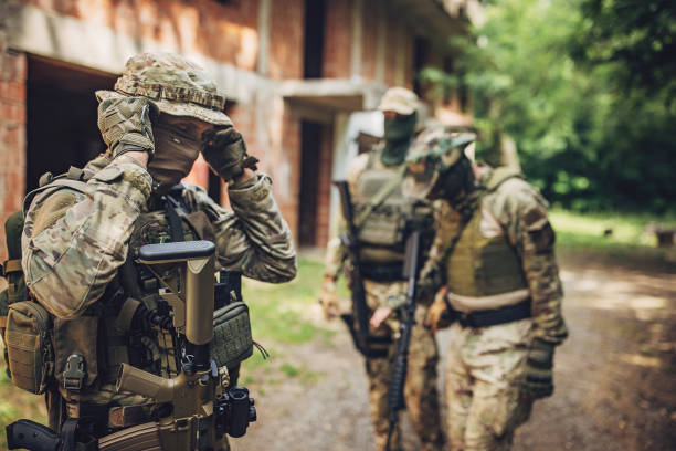 istock Soldier adjusts gear ready for mission in the forest 2163596846