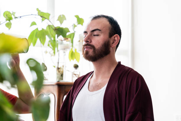 istock Mid adult man meditating at home 2163597794