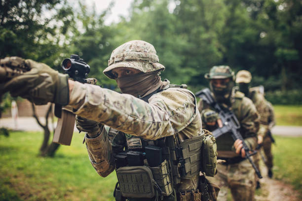 istock Team of soldiers aiming rifles during exercise. 2163597806