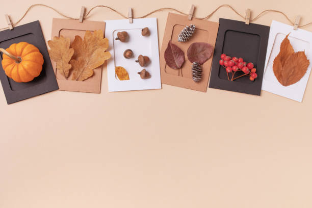 istock Autumn or fall concept. Pumpkins, berries, acorns and cones on beige table top view. 2163598245