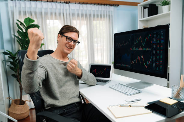 istock Smart business trader looking at camera with raising fist up. Pecuniary. 2163598638