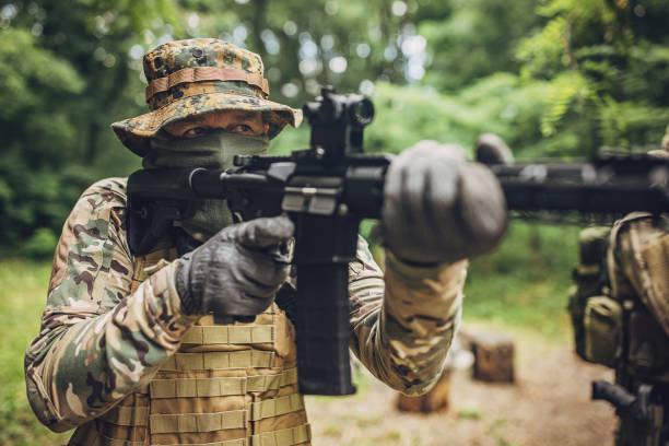 istock Camo-clad operative focusing down rifle sight 2163600020