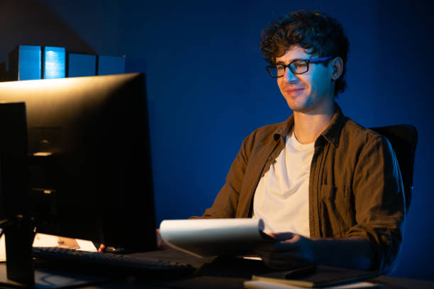 istock Young businessman reading design thinking on paper for new project. Gusher. 2163600140