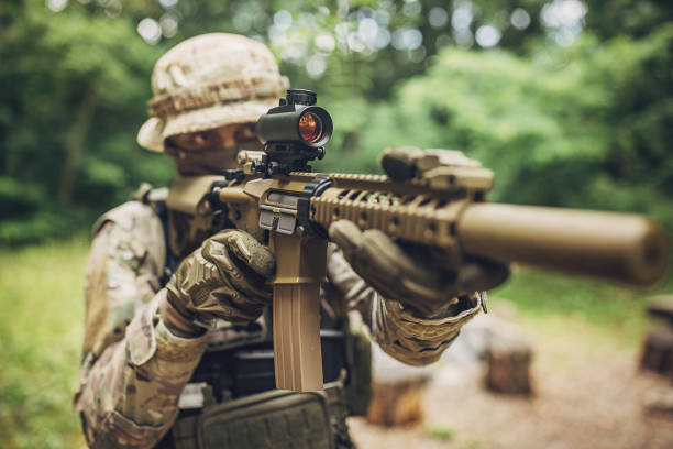 istock Soldier focuses while aiming scoped rifle to target 2163600209