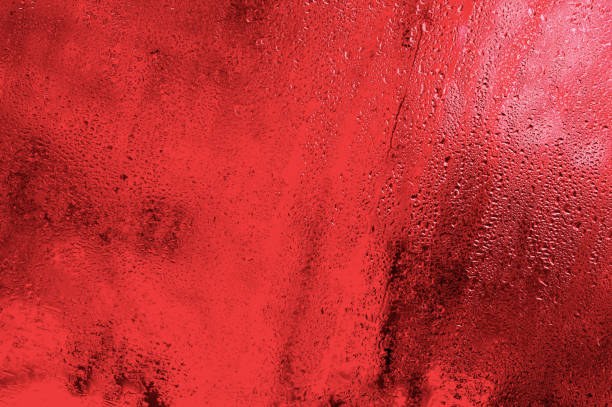 drops run down the glass. red background