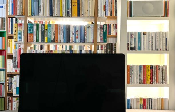 istock Compouter screen in a library, full bookshelves in the background 2163606581