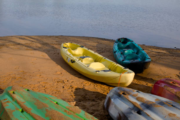 istock Serene riverside with colorful kayaks. 2163606755