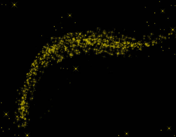 Golden flakes-glittering gold particles are scattered on the black surface.