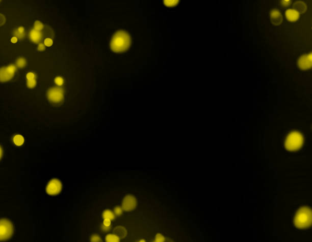 Golden flakes-glittering gold particles are scattered on the black surface.