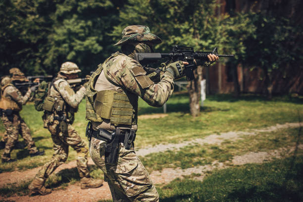 istock Armed soldier aiming rifle during field operation 2163609255