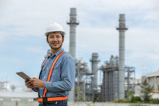 istock Engineer with tablet working factory producing electricity oil energy. Construction manager oil refinery in petrochemical. improvement inspector Industrial worker working power plant 2163611307