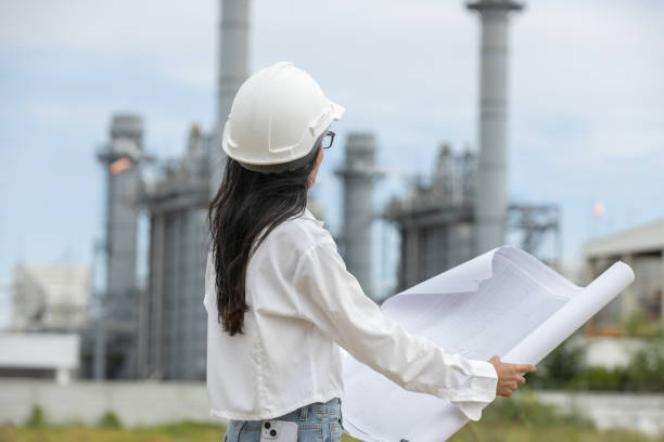 istock Engineer with blueprint working factory producing electricity oil energy. Construction manager oil refinery in petrochemical. improvement inspector Industrial worker working power plant 2163611325