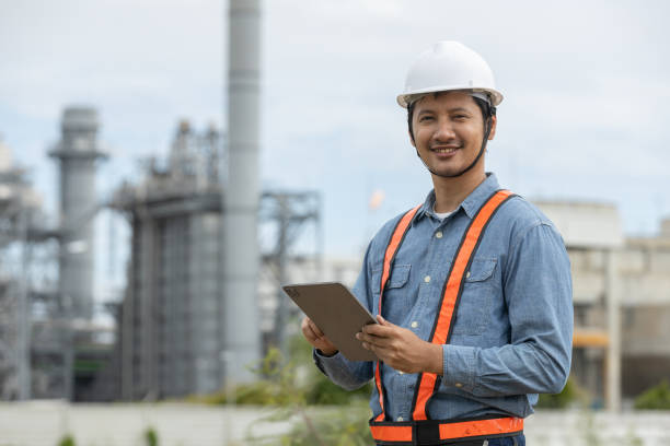 istock Engineer with tablet working factory producing electricity oil energy. Construction manager oil refinery in petrochemical. improvement inspector Industrial worker working power plant 2163611327