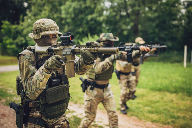 istock Tactical forces moving through a wooded area 2163611585