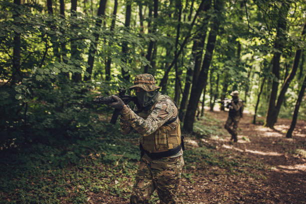 istock Tactical soldier aiming rifle in forest environment 2163615009