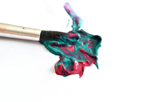 On a white background there is a stain from the combination of two paints and an artists brush.