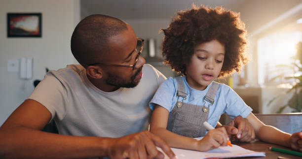 istock Father, boy and book with writing, education or helping hand for advice with problem solving in family home. African man, son and learning for development, math or check notes at apartment 2163620640