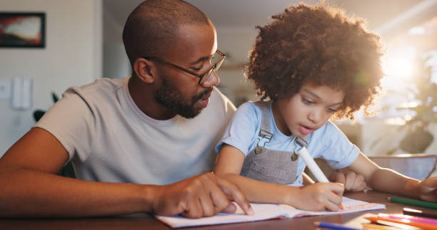 istock Father, boy and notebook with writing, education or helping hand for advice with problem solving in family home. African man, child and learning for development, math or check at apartment 2163620652