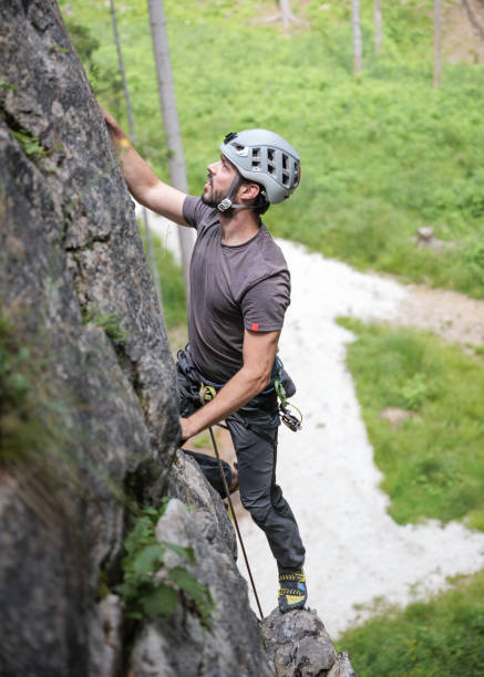 istock Climber ascending Mountain with Helmet and Gear 2163621662