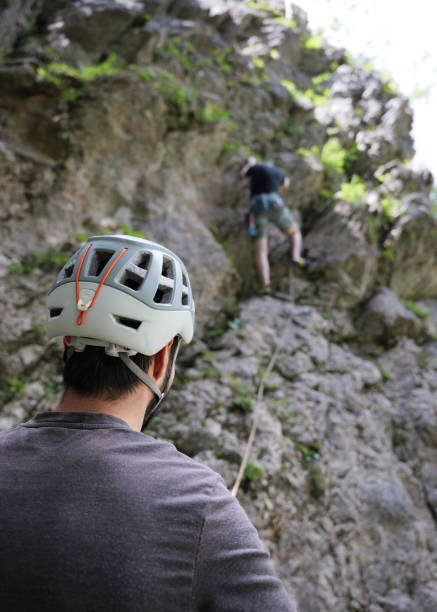 istock Climber belaying his climbing friend 2163621683
