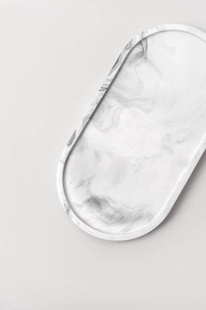 Cosmetics product presentation scene made with marble oval tray, perfect for displaying jewelry, cosmetics, or home decor items. Vertical photography.