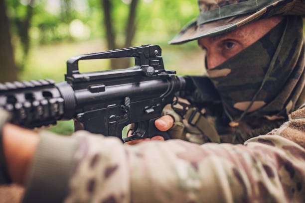 istock Soldier aiming with rifle in forest during training 2163622580