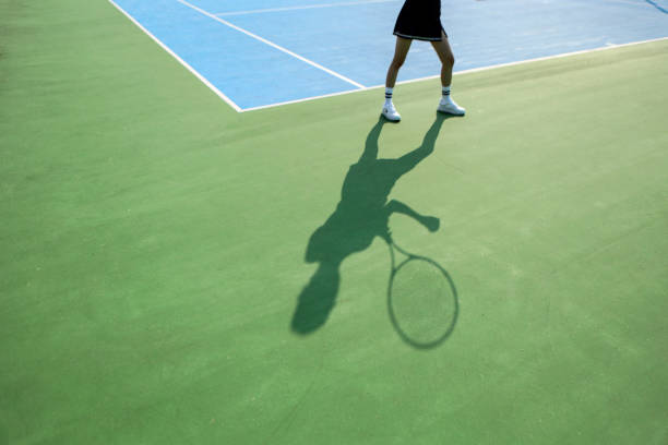 istock Young woman playing tennis 2163623030