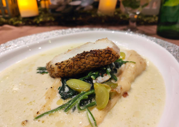 istock Pan fried barramundi with spinach in creamy sauce 2163625872
