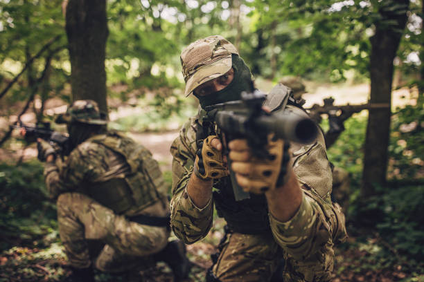 istock Camouflage soldiers engaged in a forest operation. 2163626219