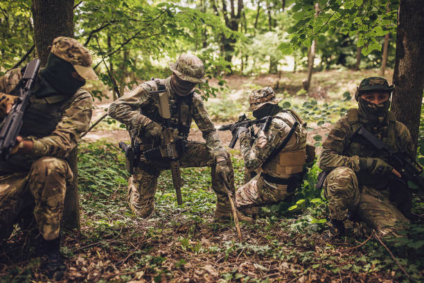 istock Group of soldiers planning in a forest setting. 2163626360