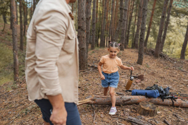 istock Father and daughter walking through the forest 2163626724