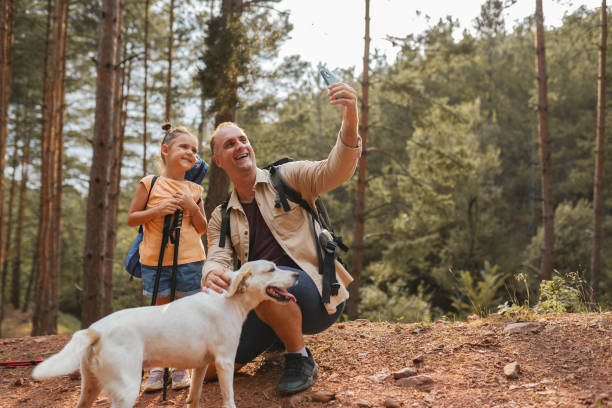 istock Father with daughter hiking and take selfie together 2163626749