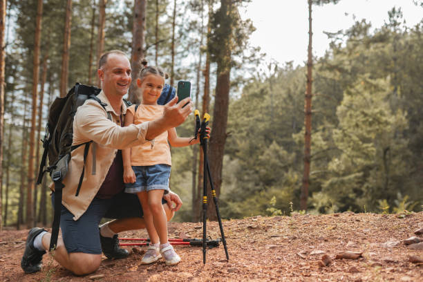 istock Father with daughter hiking and take selfie together 2163627097
