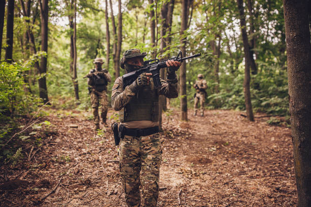 istock Soldier steadies rifle aiming within forest patrol 2163629195