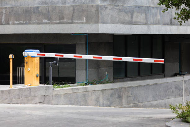 istock A red and white automatic traffic barrier is in front of a building 2163629921