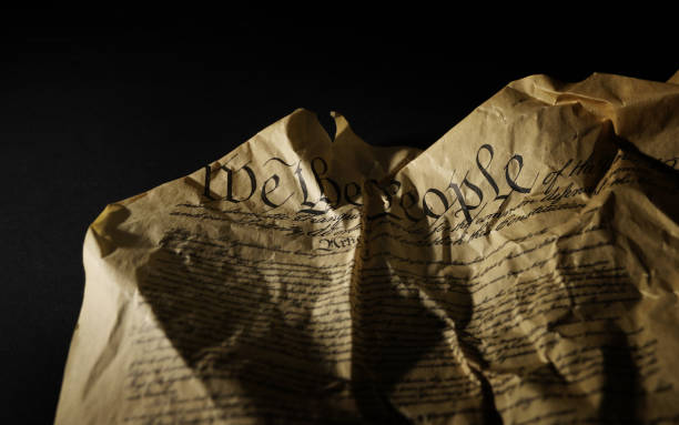 istock Wrinkled and crumpled US Constitution on dark background 2163630022