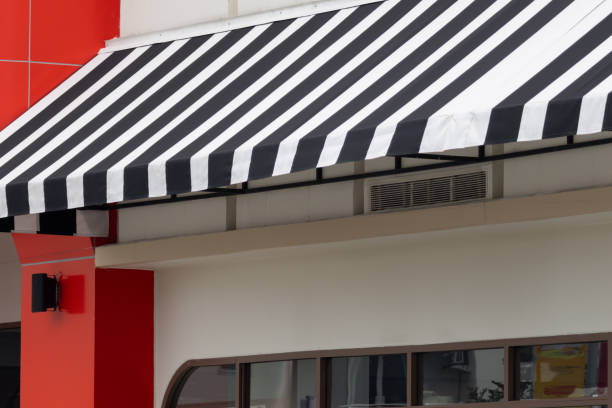 istock A black and white striped awning over a store 2163630077
