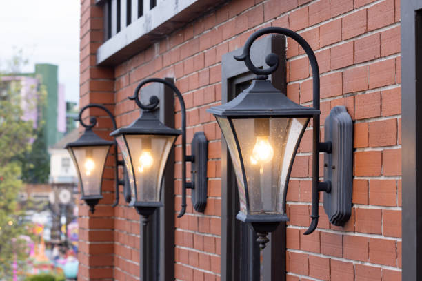 istock Three street lamps are lit up on a brick wall 2163630137