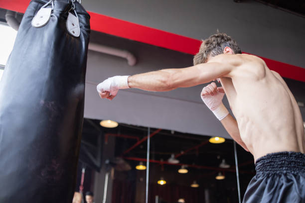 istock A man is punching a bag in a boxing gym 2163630254