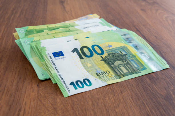 istock Concept Financial Security: Stack of Euro Banknotes on Wooden Table 2163632802