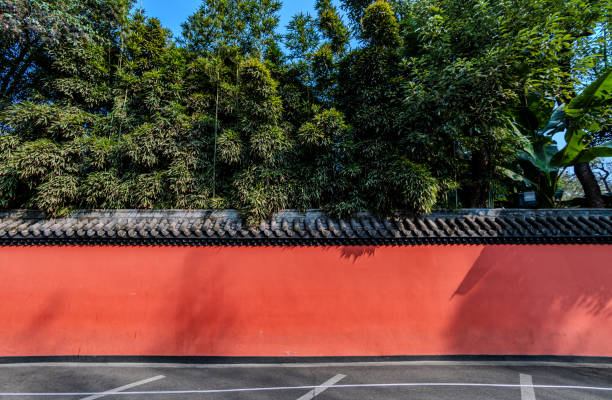 istock Red wall with green bamboo trees in the background 2163634735