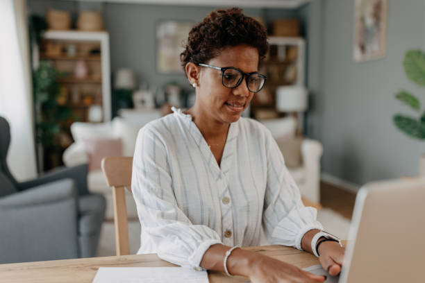 istock Woman working on laptop in a cozy home environment 2163635218