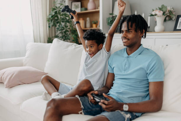 istock Father and son playing games, celebrating victory joyfully 2163635642