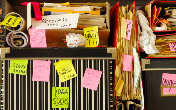 istock Messy file folder,sticky notes and old papers.Red tape, bureaucracy,overworked,burnout,exploitation,messy office and chaotic business concept. 2163635672