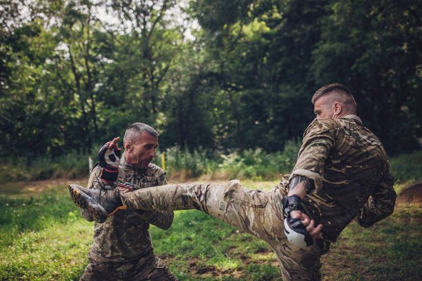 istock Combat training outdoors with leg attack by soldiers. 2163636833