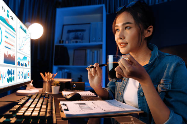 istock Thinking Asian creative woman looking on pc with pointing report. Stratagem. 2163641233